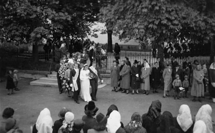 Pohřeb svobodného mladíka v Bludově před kostelem v 40. letech 20. století.